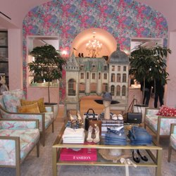 Heart of the store: large scale birdcage and chairs with a coffee table of unique retail items