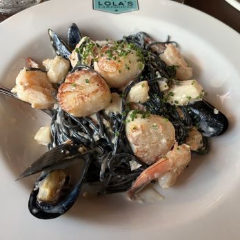 Lola's Lakehouse - Seafood Pasta. A lot of seafood with squid ink black tonnarelli pasta and lemon and white wine cream sauce. Excellent pasta dish! - American Near Me - Waconia, Minnesota Lola's Lakehouse - Seafood Pasta. A lot of seafood with squid ink black tonnarelli pasta and lemon and white wine cream sauce. Excellent pasta dish! - American Near Me - Waconia, Minnesota