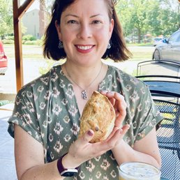 a woman holding a sandwich and a drink a woman holding a sandwich and a drink