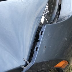 Ken's Towing & Collision Center - Broken Bumper bracket and folds in right fender Caused by Wrecker! $1000 estimate to fix.
