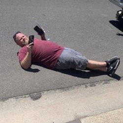 Spring King Garage Door Service Company - Brendan "Spring King" laying in the street in front of my vehicle.