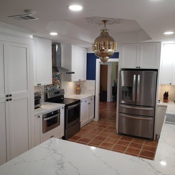 Miami Kitchens & More - a kitchen with white cabinets and a stainless steel refrigerator - General Contractors Near Me - Miami, Florida