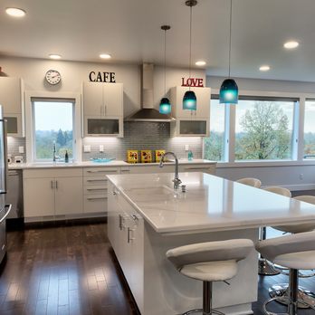 G. Christianson Construction Inc - Modern kitchen, with Cambria countertops, painted flush cabinets, glass tile backsplash, eating bar and mountain view windows - General Contractors Near Me - Corvallis, Oregon G. Christianson Construction Inc - Modern kitchen, with Cambria countertops, painted flush cabinets, glass tile backsplash, eating bar and mountain view windows - General Contractors Near Me - Corvallis, Oregon