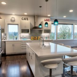 G. Christianson Construction Inc - Modern kitchen, with Cambria countertops, painted flush cabinets, glass tile backsplash, eating bar and mountain view windows