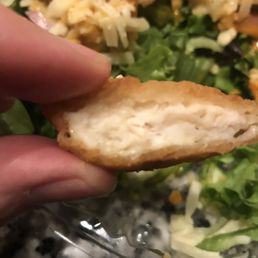 a hand holding a piece of bread