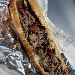 Cheesesteak with fried onions and hot cherry peppers.
