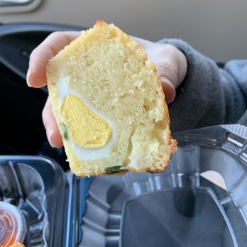 Archetype Coffee - a person holding a piece of cake - Coffee Roasteries Near Me - Omaha, Nebraska