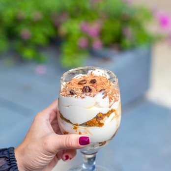 IL Grano Pizzeria - a hand holding a dessert - Pizza Near Me - Miami, Florida IL Grano Pizzeria - a hand holding a dessert - Pizza Near Me - Miami, Florida