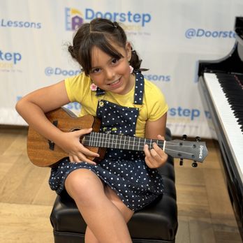 Doorstep Music Lessons - Student playing ukulele at recital - Musical Instruments & Teachers Near Me Doorstep Music Lessons - Student playing ukulele at recital - Musical Instruments & Teachers Near Me