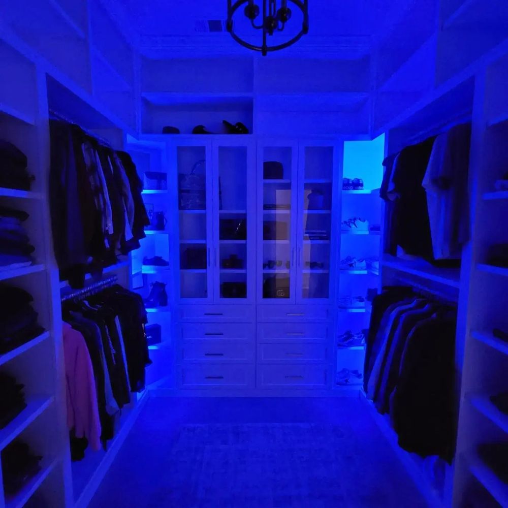 a walk - in closet with a chandelier