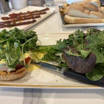 First Watch - Closer view of the BLT Eggs Benedict with Mixed Greens - Breakfast & Brunch Near Me - Plano, Texas