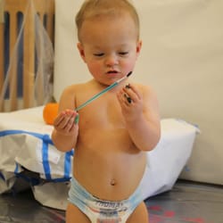 Examining the paintbrush before jumping in!