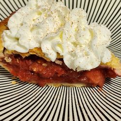 Mendon Mountain Orchards & Motel - A slice of  Strawberry-Rhubarb pie with whipped cream and cinnamon sprinkle