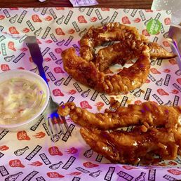 Five chicken strips with side of coleslaw. Five chicken strips with side of coleslaw.