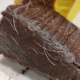 Picked up ChocoFlan cake the other day. Saw this today. Not sure what it is. Doesnt look like hair but whatever it is, it shouldn't be there Picked up ChocoFlan cake the other day. Saw this today. Not sure what it is. Doesnt look like hair but whatever it is, it shouldn't be there