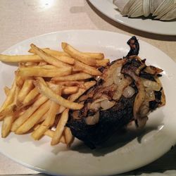 Commix Hotel - Black diamond steak with grilled onions and french fries.