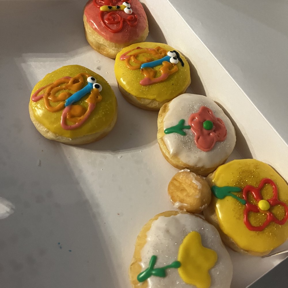 a variety of decorated donuts in a box a variety of decorated donuts in a box
