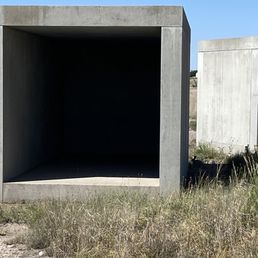 Cottontail seeking shading at right of art piece by Donald Judd Cottontail seeking shading at right of art piece by Donald Judd