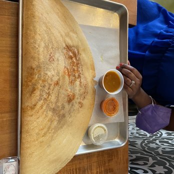 My Dosa Place - a person holding a spoon and dipping sauce - Indian Near Me - Toronto, Ontario