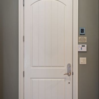 Builders FirstSource - White paneled interior door with an arched top design, set in a green wall with white trim... - Building Supplies Near Me - Salem, Massachusetts Builders FirstSource - White paneled interior door with an arched top design, set in a green wall with white trim... - Building Supplies Near Me - Salem, Massachusetts