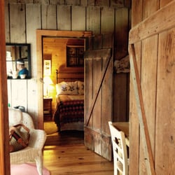 Ten Oaks - View of common area and bedroom from the bathroom in the stone cottage. Rustic charm at its finest.