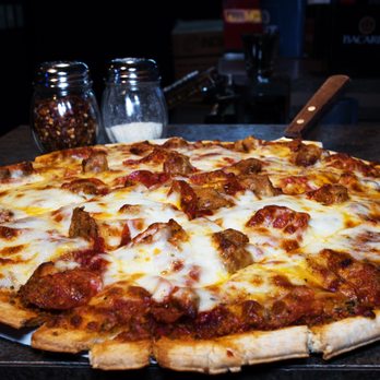 D2 Sports Pub - a pizza on a table - Sports Bars Near Me - Green Bay, Wisconsin D2 Sports Pub - a pizza on a table - Sports Bars Near Me - Green Bay, Wisconsin