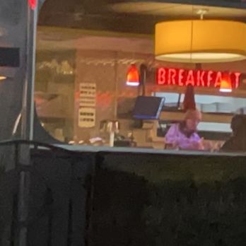 Denny's - a woman sitting at a table in a restaurant - Diners Near Me - Ruidoso Downs, New Mexico