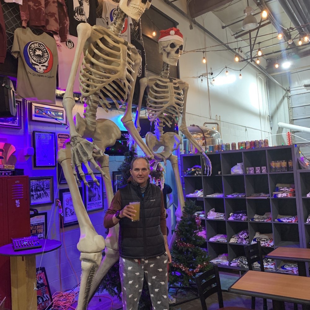 a man standing in front of a skeleton a man standing in front of a skeleton