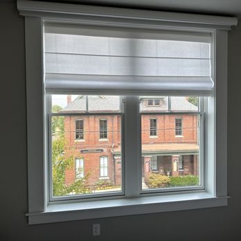 Bloomin' Blinds - Remote controlled outside mount blackout roller shade with cassette installed above and outside inside mounted light filtering roman shade, - Shades & Blinds Near Me