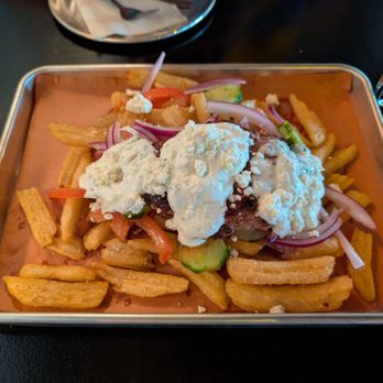 Johnny’s Garage - Meat stick. Tzatziki. Crisp fries. Onions, tomatoes, cucumbers, feta. - New American Near Me - Hanahan, South Carolina Johnny’s Garage - Meat stick. Tzatziki. Crisp fries. Onions, tomatoes, cucumbers, feta. - New American Near Me - Hanahan, South Carolina
