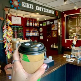 a hand holding a coffee cup