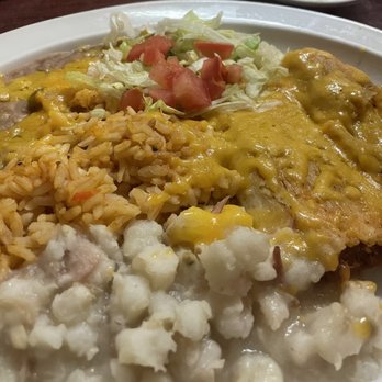 El Comal - Pork Tamales with Posole. Highly recommened. - A plate of Mexican cuisine featuring rice, a cheese-covered dish, shredded lettuce with tomatoes, and refried beans. - Mexican Near Me - Santa Fe, New Mexico