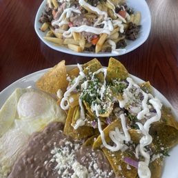 Green chilaquiles and asada fries Green chilaquiles and asada fries