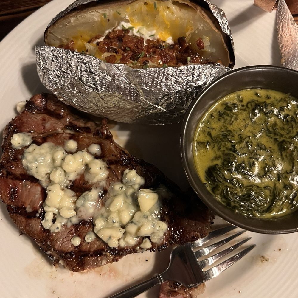 Cactus Cove Inn & Suites - New York strip with creamed spinach and loaded baked potato - Hotels Near Me - Amarillo, Texas