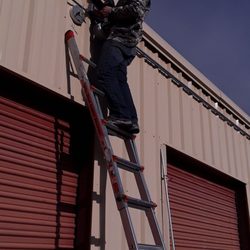 Lifemaster Security Alarms - A lifemaster worker installing a high resolution camera
