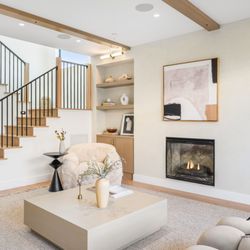 Living room remodel with fireplace, custom built-ins, and open staircase