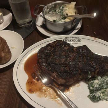 Okeechobee Steak House - Black & Blue bone in ribeye with baked potato and creamed spinach. Mm Mm GREAT!! - Steakhouses Near Me - West Palm Beach, Florida Okeechobee Steak House - Black & Blue bone in ribeye with baked potato and creamed spinach. Mm Mm GREAT!! - Steakhouses Near Me - West Palm Beach, Florida