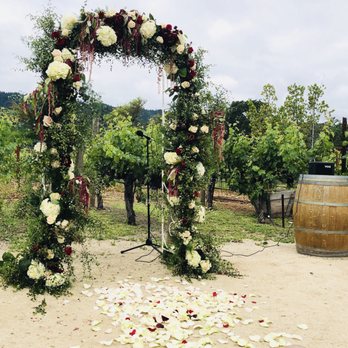 Joellen Pope Weddings - Wedding arch -- so full, with beautiful flower arrangement. The photo doesn't do it justice! - Wedding Planning Near Me Joellen Pope Weddings - Wedding arch -- so full, with beautiful flower arrangement. The photo doesn't do it justice! - Wedding Planning Near Me