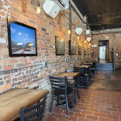 8th & Roast - 8th Ave - Indoor seating with exposed brick wall