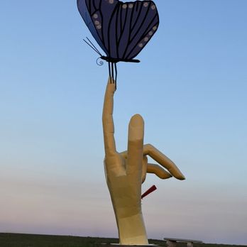 Porter Sculpture Park - Hand with a stake in it, still supporting the delicate beauty of a butterfly. - Parks Near Me - Montrose, South Dakota Porter Sculpture Park - Hand with a stake in it, still supporting the delicate beauty of a butterfly. - Parks Near Me - Montrose, South Dakota