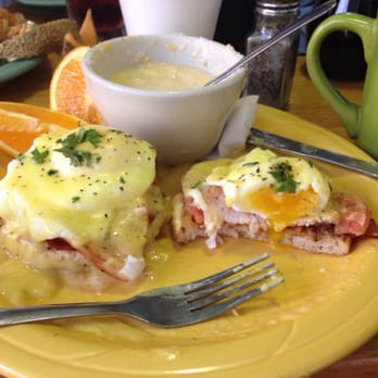 J Christopher's - Signature Eggs Benedict Dish with cheese grits and oranges. - New American Near Me - Savannah, Georgia
