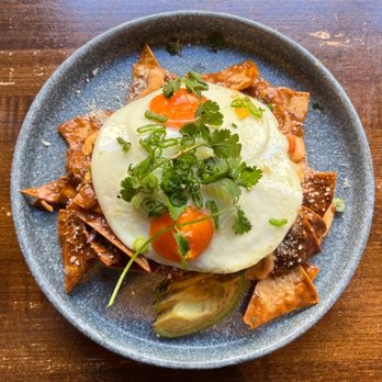 Haven Craft Kitchen + Bar - duck confit chilaquiles: chipotle crema, house made mole, avocado,picot, pickled onion, fried eggs + cojita = $20 - New American Near Me - Orange, California