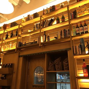 Petit Comite - Behind-the-bar (alcohol bottles and books) - Mediterranean Near Me - Seville, SE