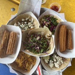 Churro, Brisket Taco, Bacon Breakfast Taco, Shrimp Taco and Fish Taco