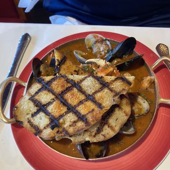 Scott's Seafood - Underneath the grilled buttered garlic toast, you will see Cioppino full of seafood. - Seafood Near Me - Oakland, California Scott's Seafood - Underneath the grilled buttered garlic toast, you will see Cioppino full of seafood. - Seafood Near Me - Oakland, California