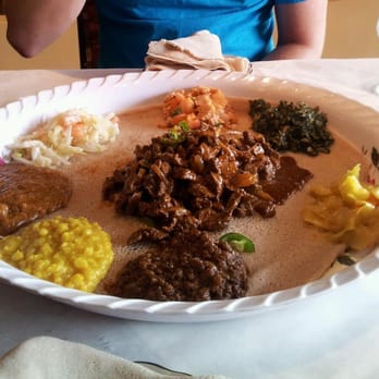 Meaza Restaurant - Awaze Tibs in the middle and Ye Tsom Wot -around the outside with the injira bread underneath. SOOO GOOD!!! - Ethiopian Near Me - Falls Church, Virginia