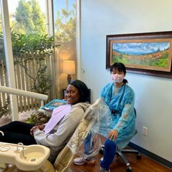 Sunny Dental - Beautiful dentist with her patient