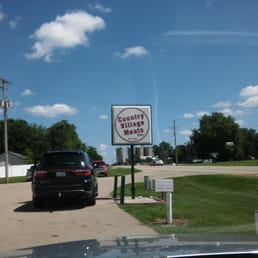 a car parked in front of a sign