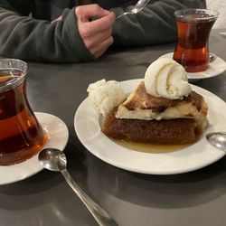 Özsüt - Bread that is fried and soaked in honey syrup, then topped with Turkish rice pudding with pistachios, and served with ice cream. YUM!