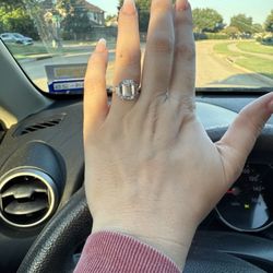 Markham Fine Jewelers - Platinum 4ct emerald-cut center, trapezoid sides, 5ct total, 2 mm cathedral band with bridge setting.